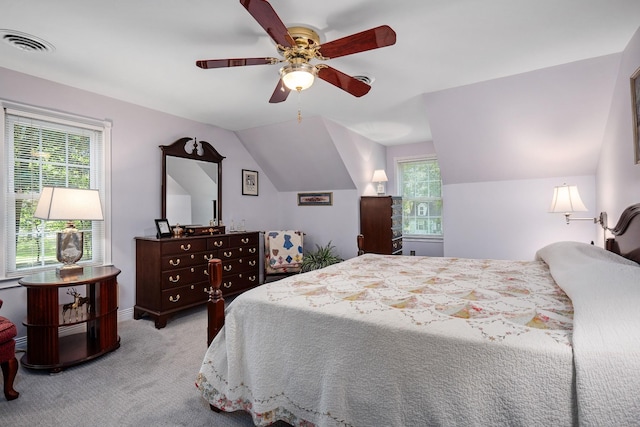 carpeted bedroom with vaulted ceiling and ceiling fan