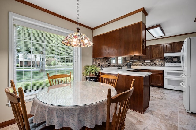 dining space with ornamental molding and sink