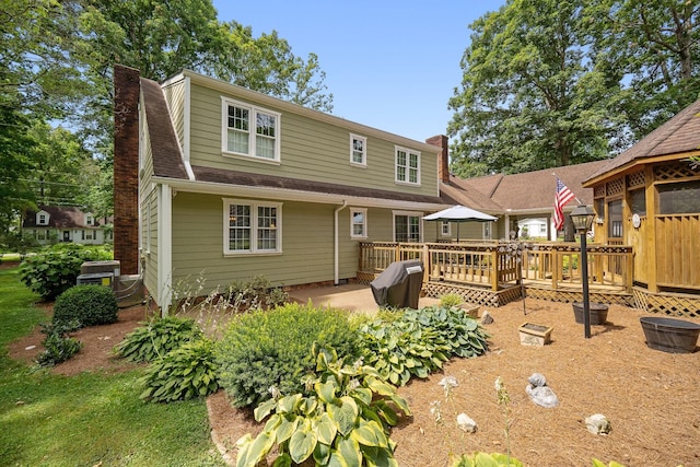 back of house featuring a wooden deck