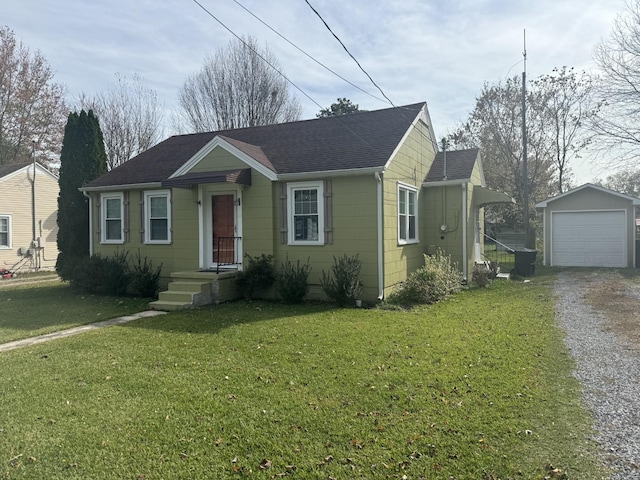 bungalow featuring a garage, an outdoor structure, and a front yard