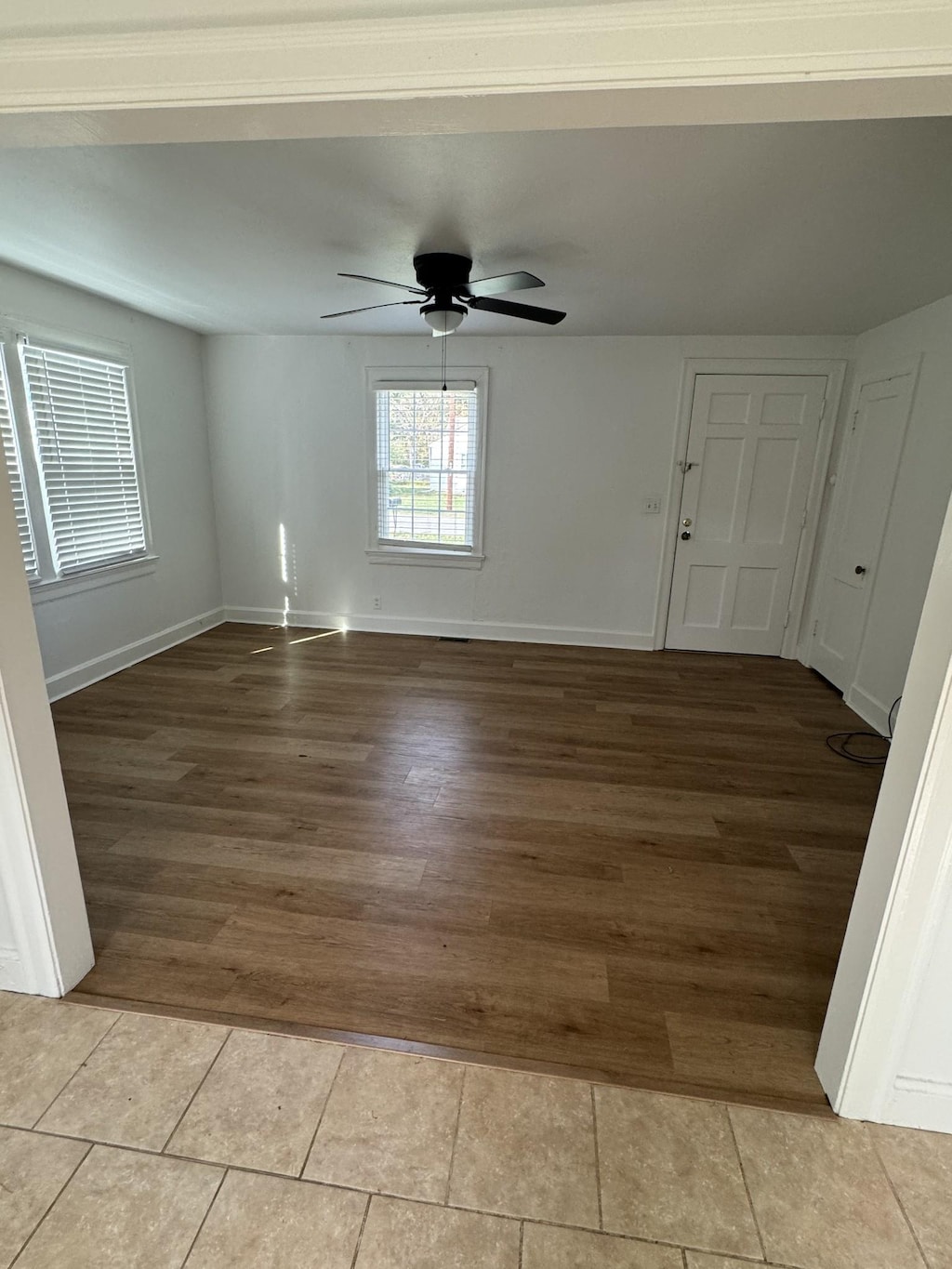 tiled empty room with ceiling fan