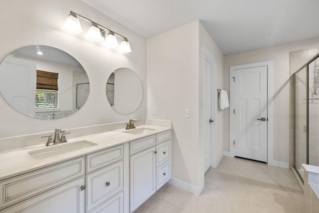 bathroom featuring tile patterned floors, vanity, and an enclosed shower