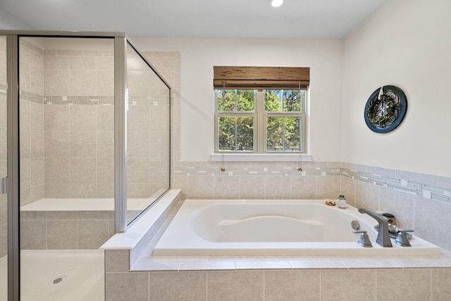 bathroom featuring independent shower and bath