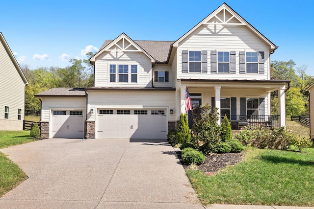 craftsman house with a garage, a front yard, and a porch