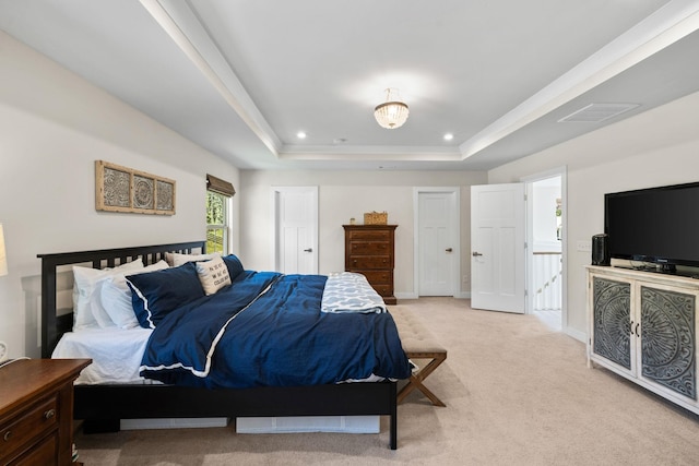 carpeted bedroom with a tray ceiling