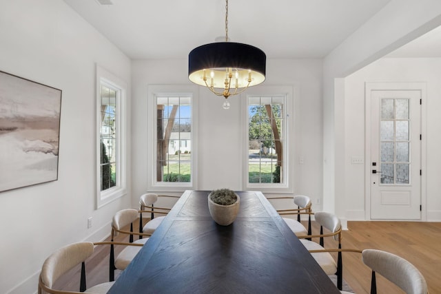 dining area featuring a chandelier and light hardwood / wood-style flooring