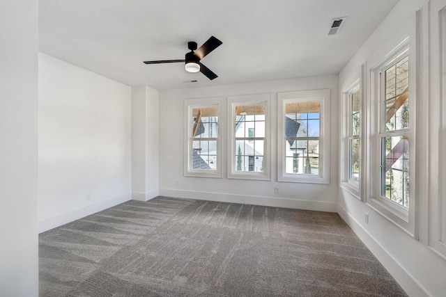 unfurnished sunroom with ceiling fan