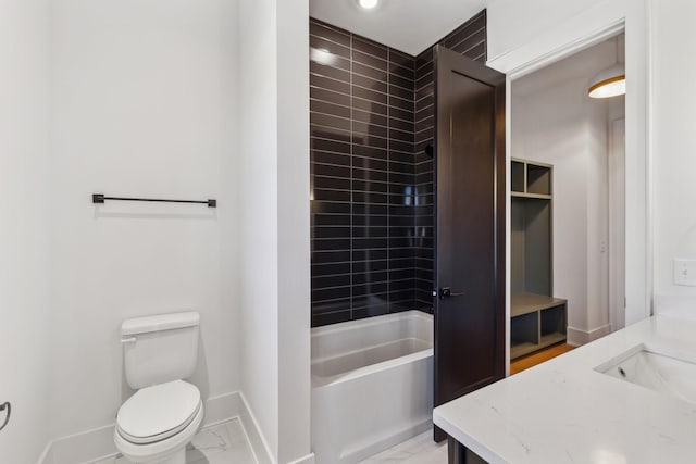 full bathroom with vanity, tiled shower / bath, and toilet