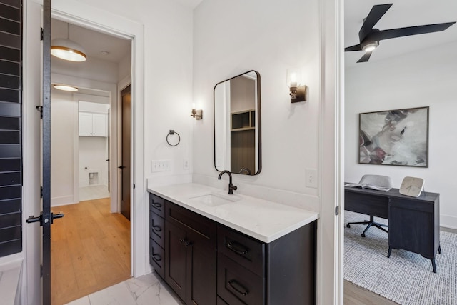 bathroom with vanity, hardwood / wood-style flooring, and ceiling fan