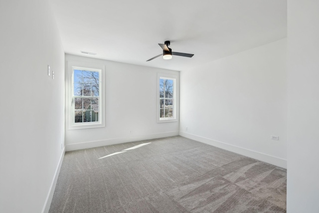 spare room featuring light carpet and ceiling fan