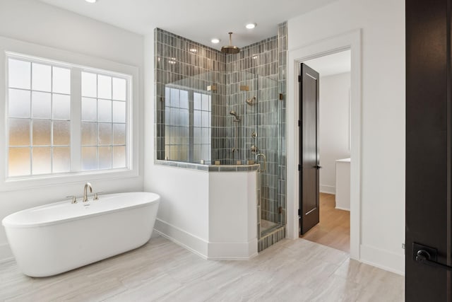 bathroom featuring shower with separate bathtub