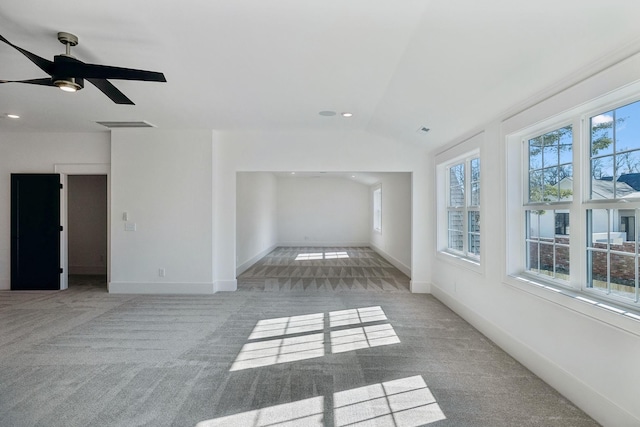 carpeted empty room with lofted ceiling and ceiling fan