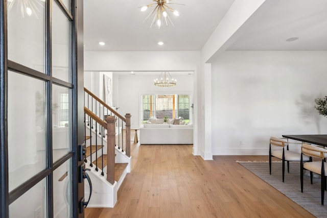 entrance foyer with an inviting chandelier and light wood-type flooring