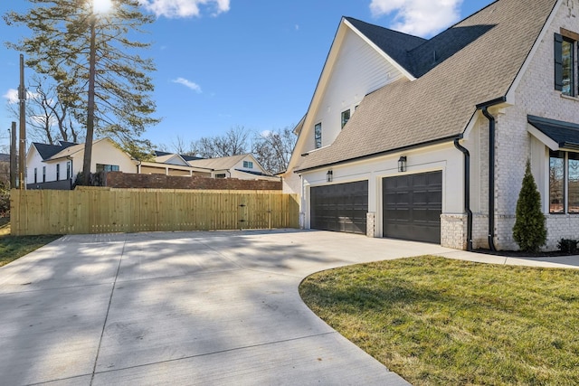 view of property exterior featuring a yard and a garage