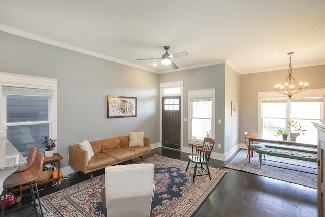 living room with dark hardwood / wood-style flooring, ceiling fan with notable chandelier, and ornamental molding