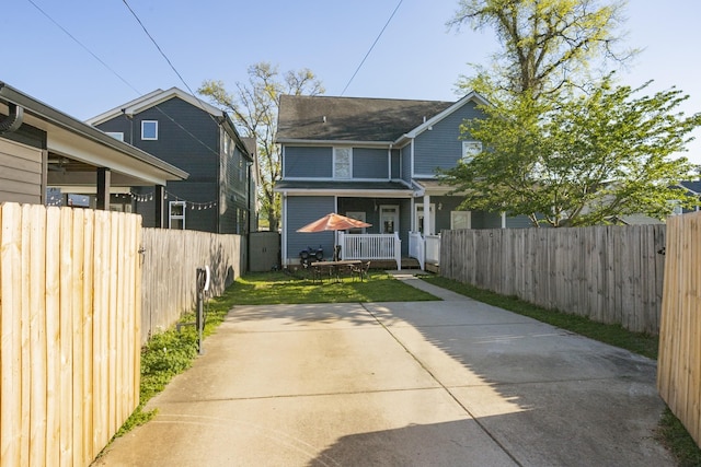 rear view of property featuring a yard and a patio area