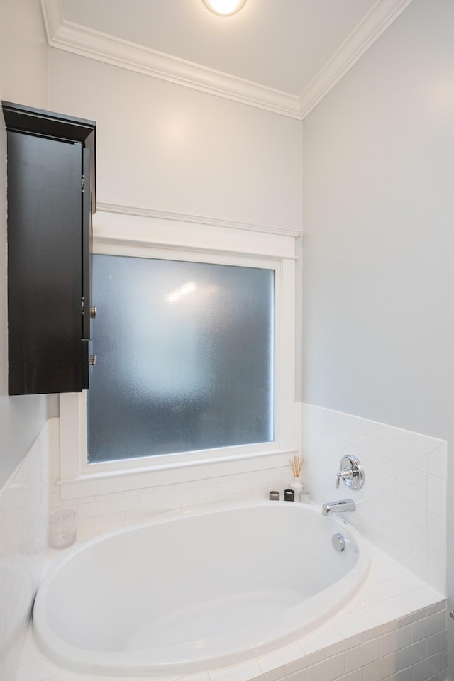 bathroom with tiled tub and crown molding