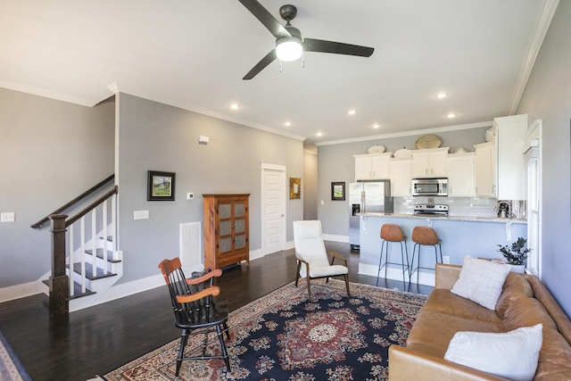 living room with crown molding, hardwood / wood-style flooring, and ceiling fan