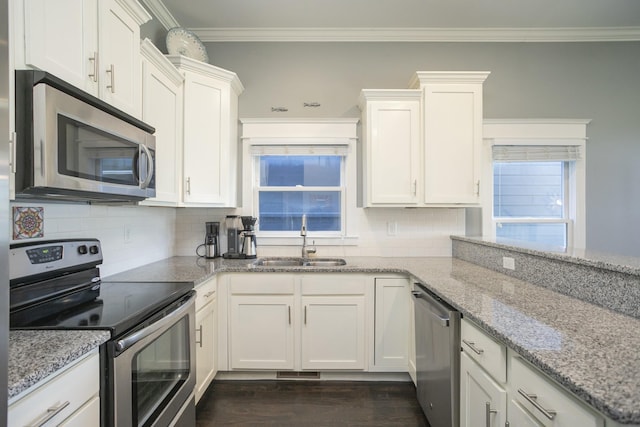 kitchen featuring light stone countertops, appliances with stainless steel finishes, sink, and white cabinets