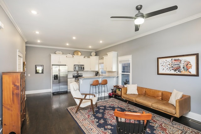 living room featuring ornamental molding, dark wood-type flooring, and ceiling fan