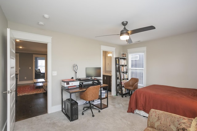 carpeted bedroom with ceiling fan and multiple windows