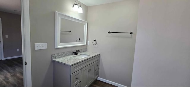 bathroom with hardwood / wood-style flooring and vanity