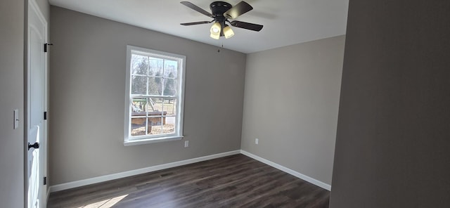 spare room featuring ceiling fan, a healthy amount of sunlight, and dark hardwood / wood-style floors