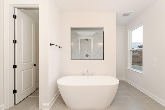 full bathroom with baseboards, visible vents, a soaking tub, tile patterned floors, and walk in shower