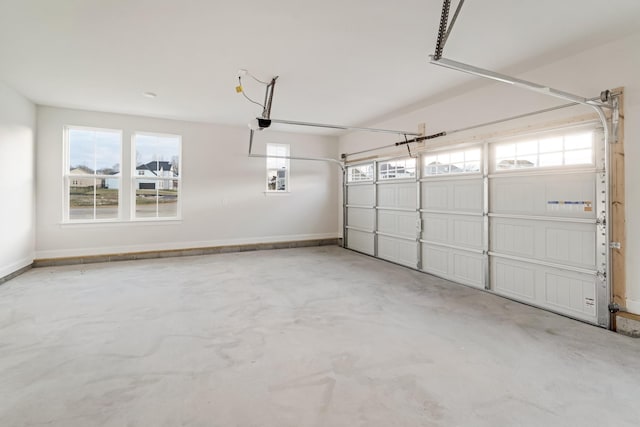 garage with baseboards and a garage door opener