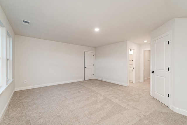 unfurnished room with recessed lighting, visible vents, light carpet, and baseboards