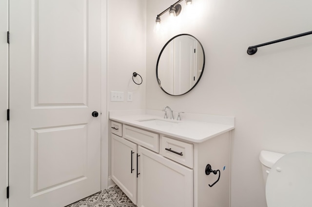 bathroom featuring toilet and vanity