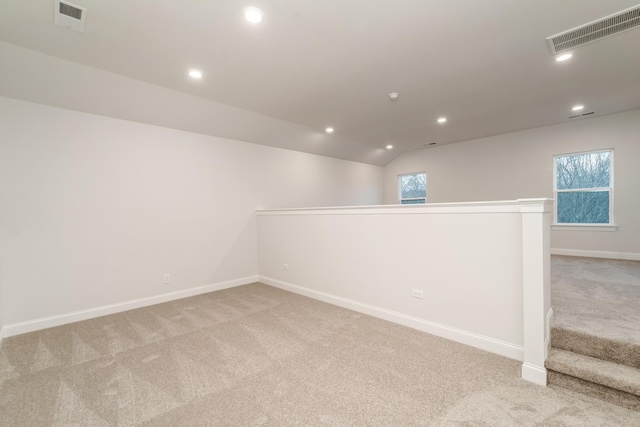 unfurnished room featuring light carpet, visible vents, and recessed lighting