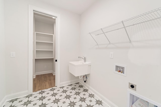 washroom with hookup for an electric dryer, laundry area, washer hookup, baseboards, and light floors