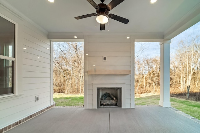 view of patio / terrace with a fireplace and a ceiling fan