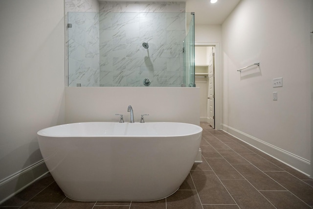 bathroom with tile patterned floors and separate shower and tub