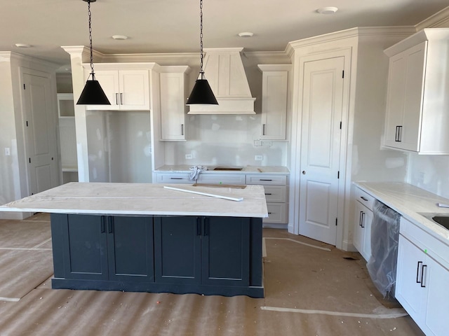 kitchen featuring hanging light fixtures, an island with sink, stainless steel dishwasher, and white cabinetry