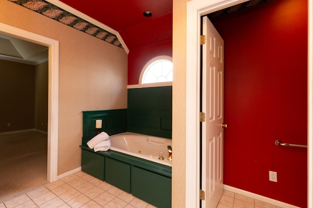 bathroom featuring tile patterned flooring, vaulted ceiling, ornamental molding, and a tub to relax in