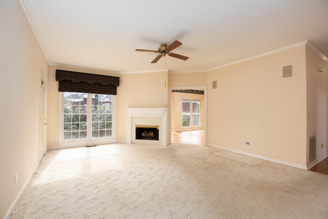 unfurnished living room with crown molding, light colored carpet, and ceiling fan