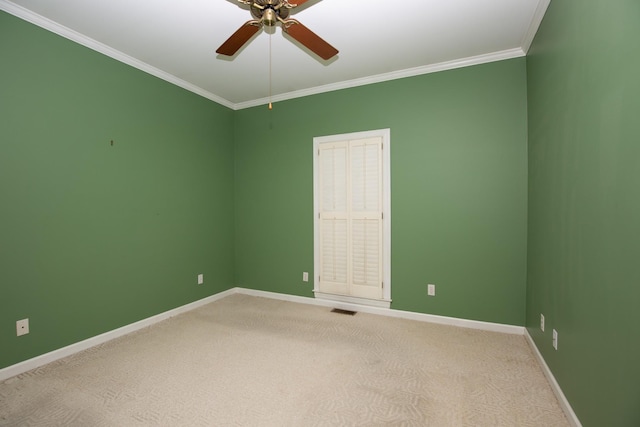 carpeted empty room featuring crown molding and ceiling fan