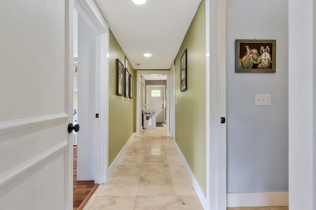 hall featuring light tile patterned floors