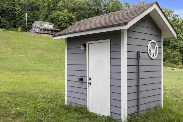 view of outbuilding featuring a lawn