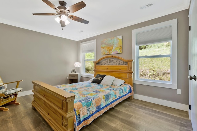 bedroom featuring crown molding, ceiling fan, and hardwood / wood-style floors