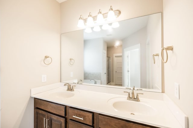 bathroom featuring vanity and a tub to relax in