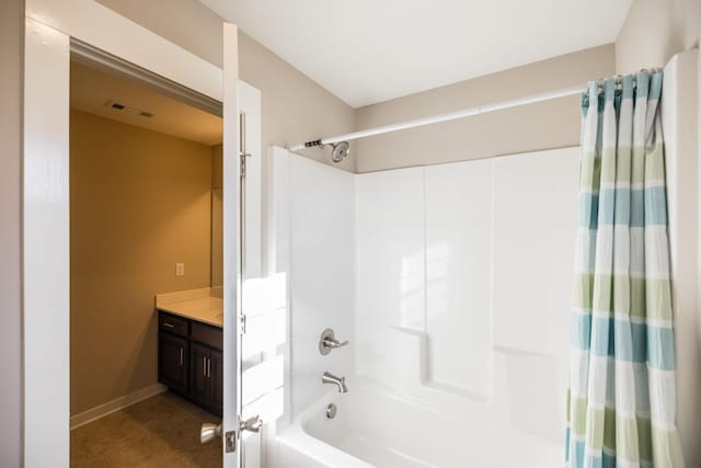 bathroom featuring tile patterned flooring, vanity, and shower / tub combo with curtain