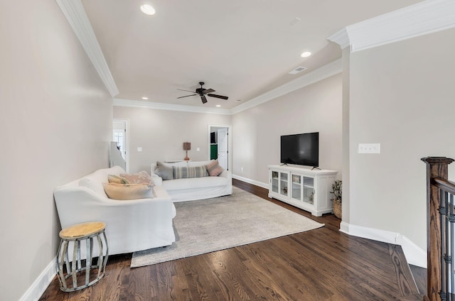 living room with ornamental molding, dark wood-type flooring, and ceiling fan