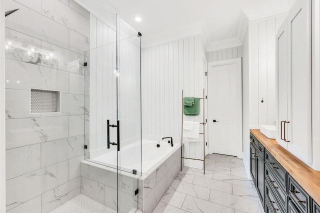 bathroom featuring vanity, ornamental molding, and separate shower and tub