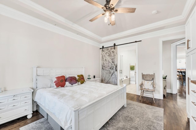 bedroom with crown molding, dark wood-type flooring, a barn door, and ceiling fan