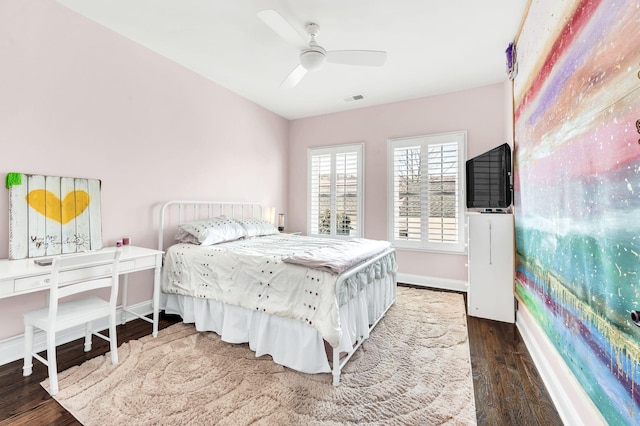 bedroom with ceiling fan and dark hardwood / wood-style floors