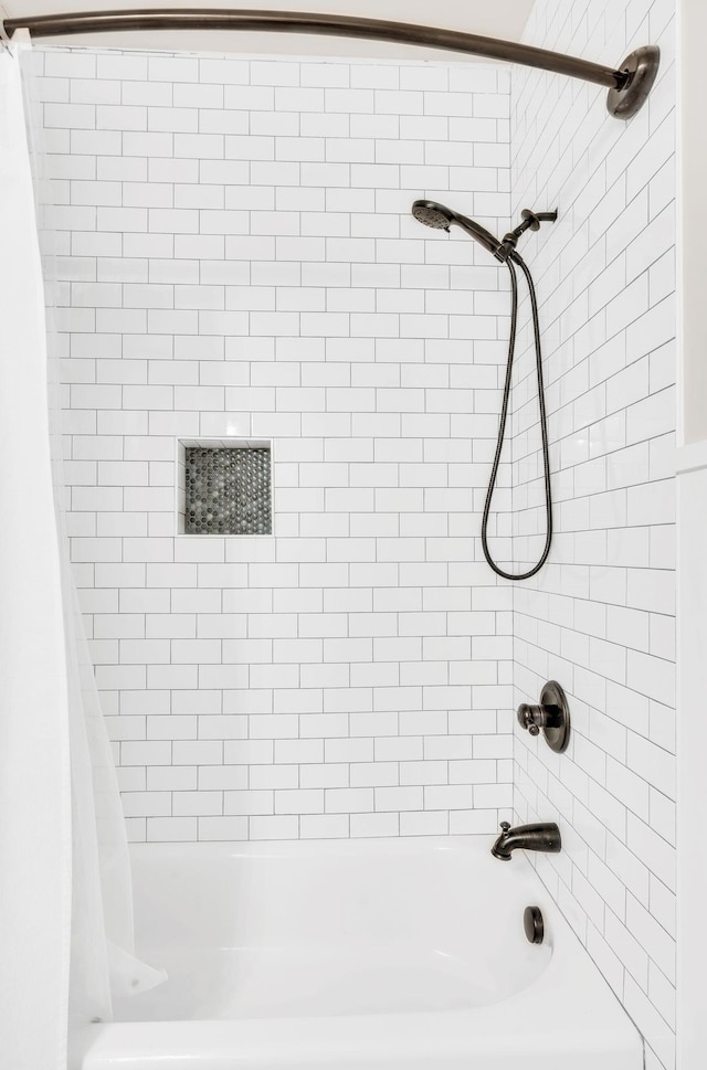 bathroom with shower / bath combo with shower curtain