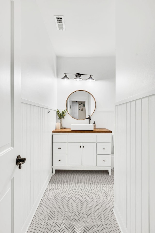 bathroom featuring vanity and toilet